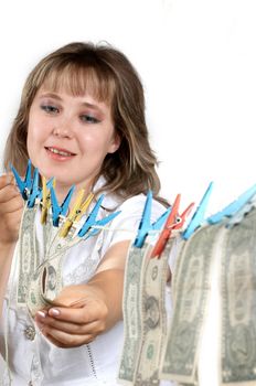 An image of smilling woman hanging up dollars