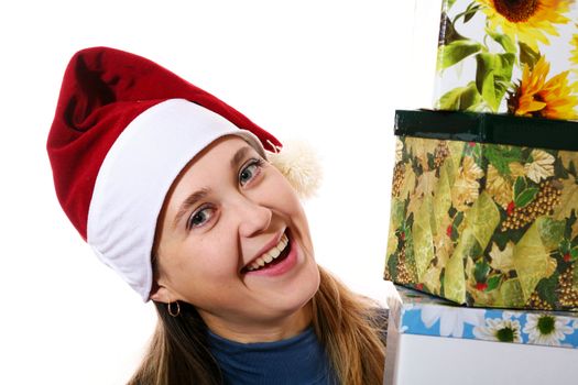 A smiling girl in a christmas cap with three boxes