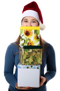 A surprised girl in a new year cap with three gift boxes