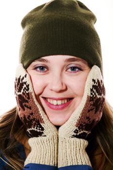 An image of a smiling girl in mittens and green hat