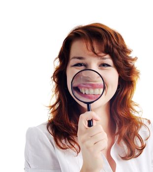 A nice woman with magnifying glass showing her teeth