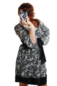 An image of a woman in a dress taking photos