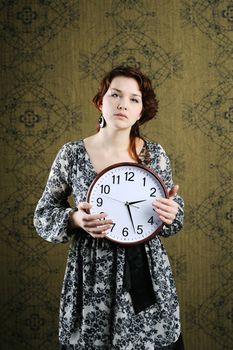 An image of a woman with a big clock