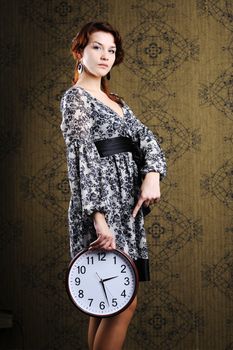 An image of a woman with a big clock