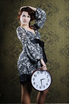 An image of a nice woman with a big clock