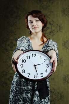 An image of a nice woman with a big clock