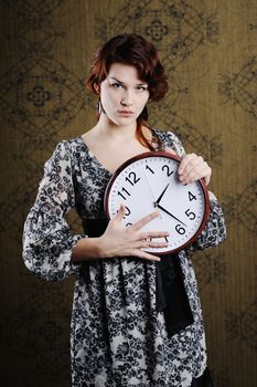 An image of a nice woman with a big clock