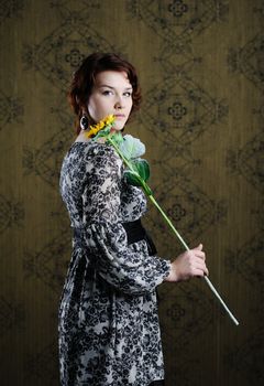 An image of a woman with a yellow flower