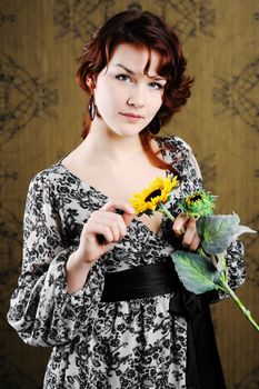 An image of young woman with sunflower