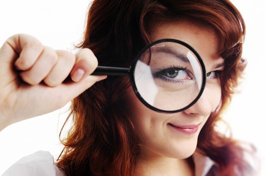 A young woman with magnifying glass at her eye