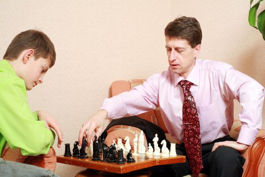 A father and his son playing chess