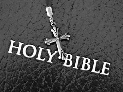 black Holy Bible with metal cross on the top of the cover