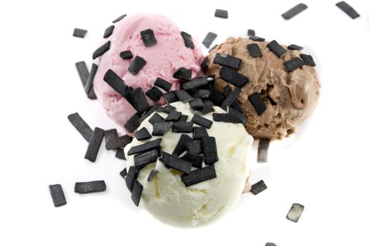 Picture of three different sort of icecream flavours with licorice on top