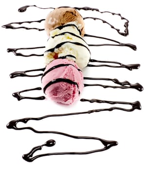 Tricolor scoops on a row with melted chocolate lines