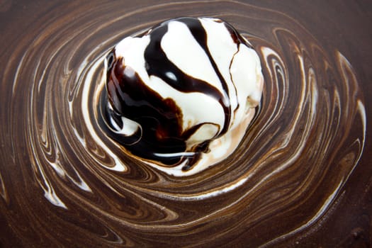 Picture of chocolate texture mixed with some icrecream with a scoop of icecream in the middle