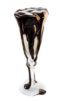 Icecream in a wine glass with massive amounts of chocolate topping