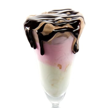 Picture of three different sort of icecream flavours in a wine glass with chocolate on top