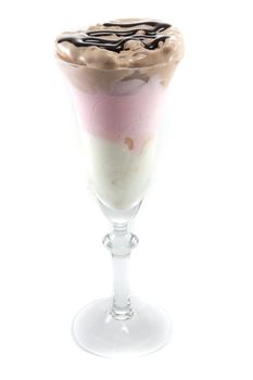 Picture of three different sort of icecream flavours in a wine glass with chocolate on top