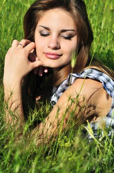 spring beautiful teen girl laying on the meadow