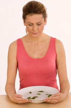 Woman inhaling the aroma of fresh herbs