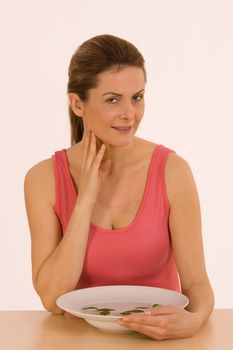 Beautiful woman inhaling scent of fresh herbs