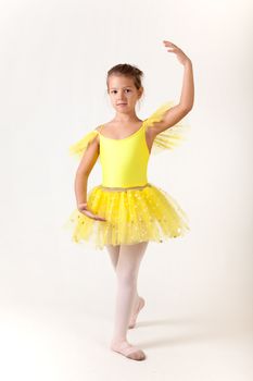 Cute little girl as ballet dancer, studio shot on white background