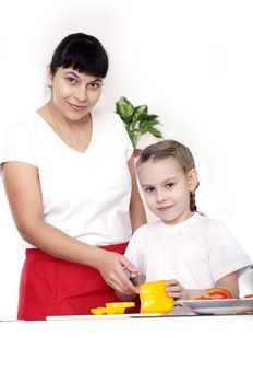 Mother and daughter cooking vegetable salad together