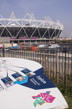 LONDON, UK – MARCH 24: Details of information board with London Olympics logo and Olympic Stadium in the background on March 24, 2012 in London. The Olympic Park is due to be ready in summer for the games.