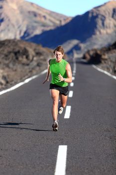 Running. Male athlete running training for marathon on beautiful mountain road. Man fitness sports model sprinting fast.