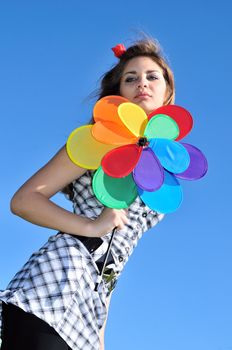 girl with windmill over the blue sky