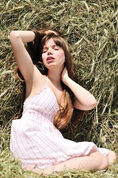 Woman lying in dry grass and relaxing