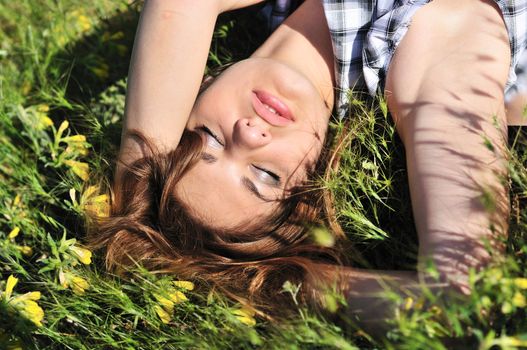 tender girl resting on the spring meadow