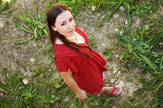 Young beautiful woman in red from above. 