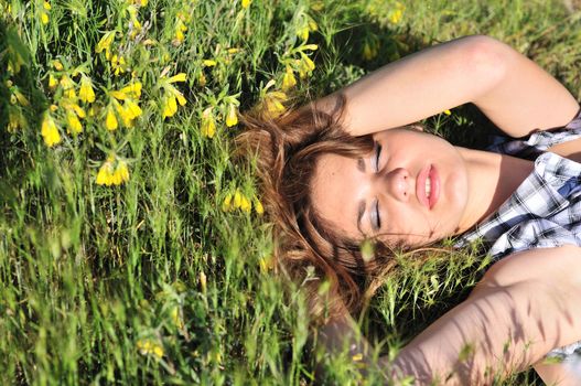 tender girl resting on the spring meadow 