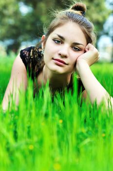 elegant teen girl laying on the meadow