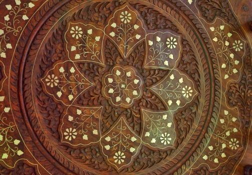 Wooden background with floral ornamental pattern and metall elements