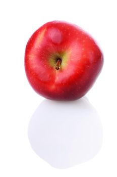 Fresh red apple with stem and reflection on white background