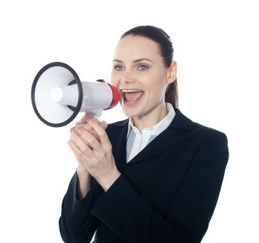 Pretty lady giving instructions with megaphone against white background