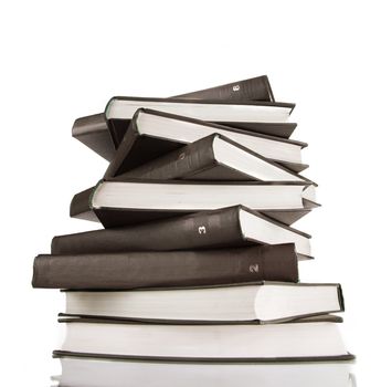 Stacked books, low angle view, isolated on white background 