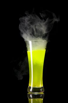 Yellow radioactive smoking alcohol, studio shot isolated on black background 