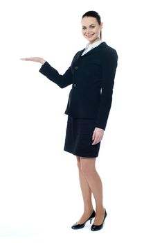 Full length of beautiful business woman showing copyspace up over white background