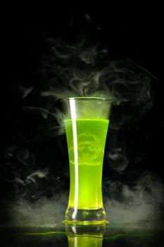 Green radioactive alcohol with biohazard symbol inside, isolated on black background 