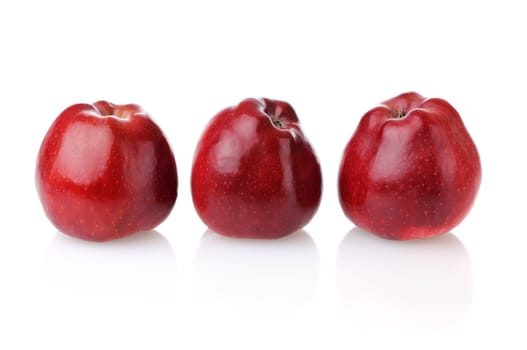 Three fresh red apples with reflection on white background