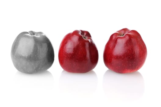 Different colourless apple with three fresh red apples on white background