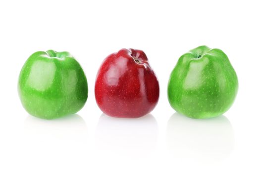 Different bright red apple between two green apples on white background