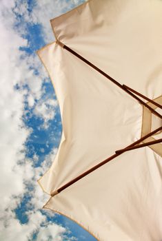 Relaxing on the beach - low angle view of white beach umbrella 