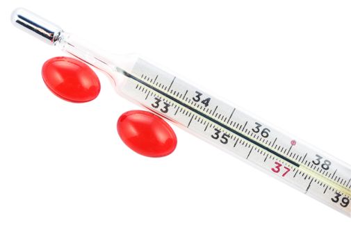 Thermometer with 37,5 degrees and two red capsules