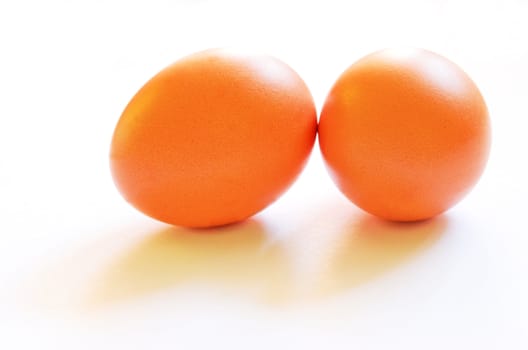 Two brown chicken's eggs with soft shadows