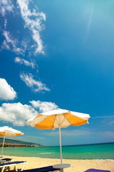 Orange umbrellas and chairs on beautiful beach 