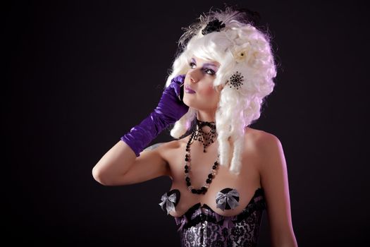 Funny shot of burlesque woman in colonial wig speaking on phone 